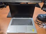 a laptop that is sitting on a desk next to a monitor