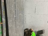 a pile of bags of garbage next to a metal radiator