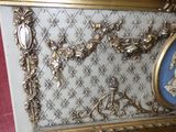 a gold frame with a picture of a woman on it