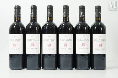 six bottles of wine are lined up in a row on a table