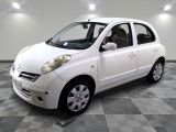 a picture of a small white car parked in a garage