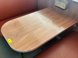 a table with a wooden table top in a booth