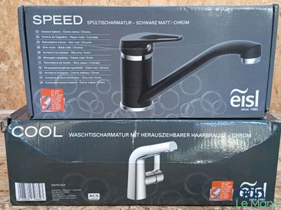 the box of the faucet is sitting on top of the box
