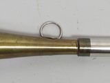a brass bell with a ring on top of it