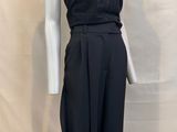 the mannequin is wearing a black top and black pants