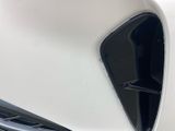 the front end of a white car with the hood open
