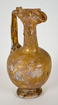 a brown vase that is sitting on a white surface
