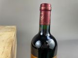 a bottle of wine sitting on a table next to a box