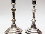 pair of silver candlesticks on a white background