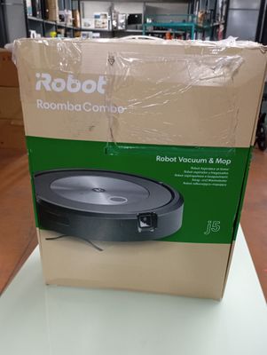 the box of the robot vacuum is sitting on the table