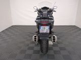 a motorcycle that is parked in a room with a checkered floor