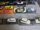 many different types of toy cars on display in a display case