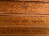 a wooden dresser with a marble top in a room