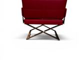 a red leather chair with a wooden frame and metal legs