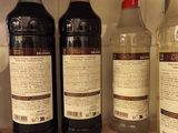 several bottles of alcohol are lined up on a counter