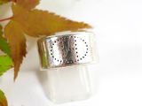 a silver ring sitting on top of a white surface