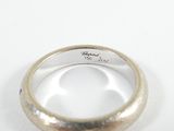 a close up of a wedding ring with a diamond in it