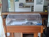 a small table with a glass case on it