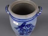 a blue and white vase with a bird on it