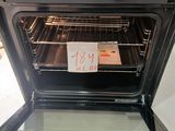 a black oven with the door open and a price tag on it
