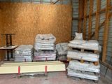 a pile of boxes and pallets in a storage room