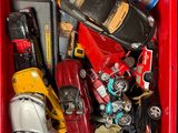 a red box filled with assorted toy cars