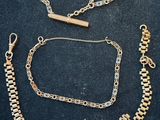 a collection of gold jewelry including a bracelet, bracelet, and necklace