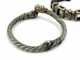 pair of antique silver bracelets with skulls on them on a white surface