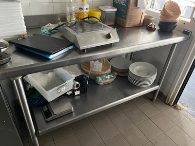 a table with a bunch of dishes on it in the kitchen