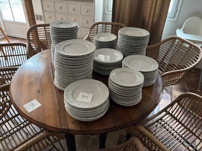 a lot of plates on the table and chairs