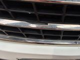a close up of a car ' s grille with a number plate on it