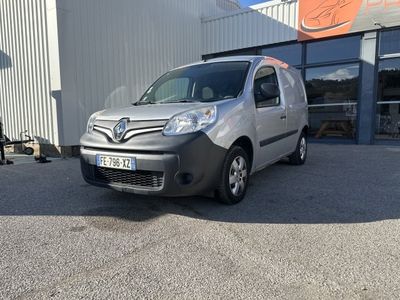 the grey van is parked in front of a building