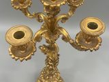 gold plated candelabra with five candles on a stand