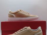 men ' s tan leather sneakers with white soles on top of a red box