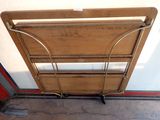 a wooden bed with a metal frame on the floor