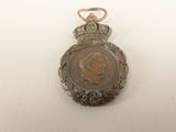 an image of a medal with a crown on it on a white surface
