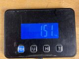 a digital clock on a table with a charger