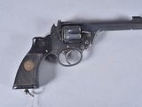 a gun that is sitting on a white surface