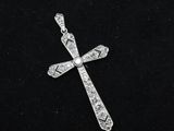 a diamond cross pendant on a black velvet surface