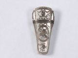 a silver ring with a design on it on a white surface