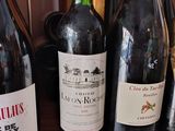 several bottles of wine are lined up on a counter