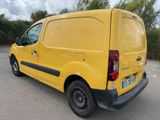 the yellow van is parked in a parking lot with trees in the background