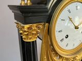 a black and gold clock sitting on a table