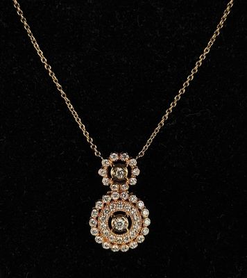 a gold and diamond pendant on a black background