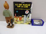 a figurine of a man standing next to a book