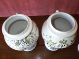 two vases that are sitting on a table