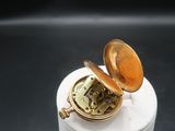 a small white container with a clock inside of it