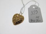 a gold heart pendant with a price tag attached to it