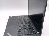 a laptop with a black keyboard on a white surface