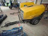 a yellow trailer with a yellow trailer attached to it